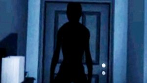 Due cacciatori di fantasmi con la torcia dentro una casa buia in Phasmophobia