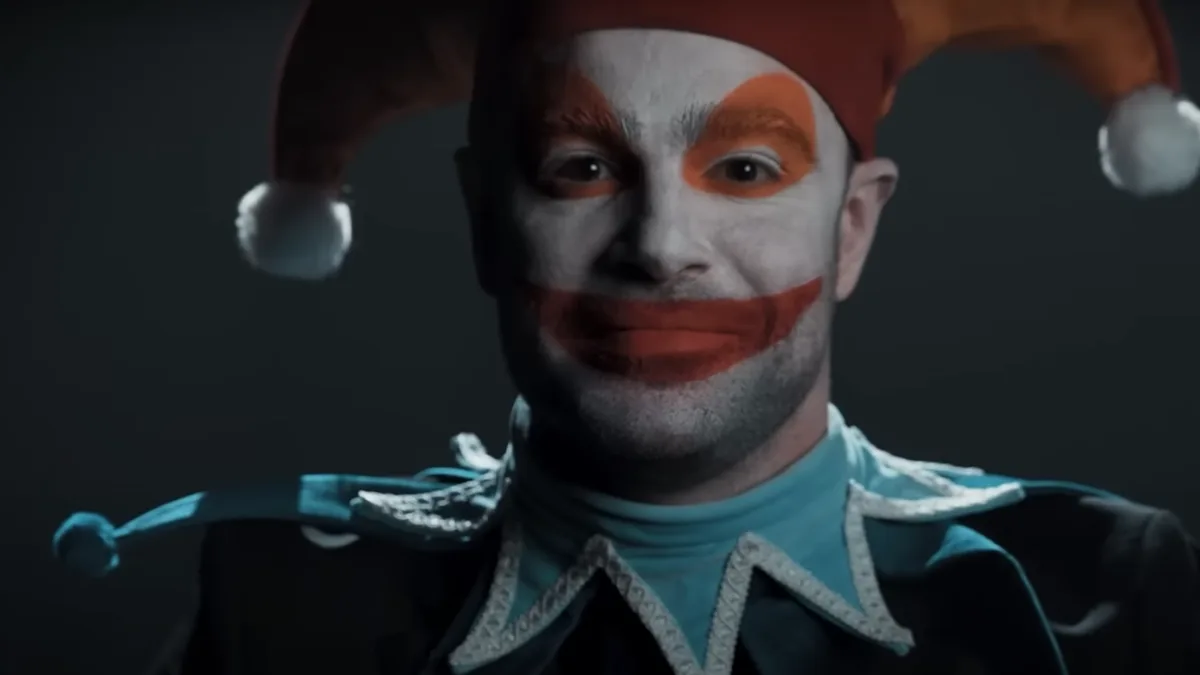 The jester from Balatro, portrayed in unsettling detail in real life, wears an uncanny smile and stares at the viewer.