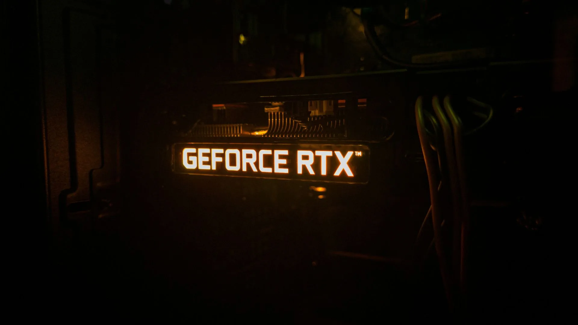 GeForce RTX backlighting on a graphics card lighting up in a dark room