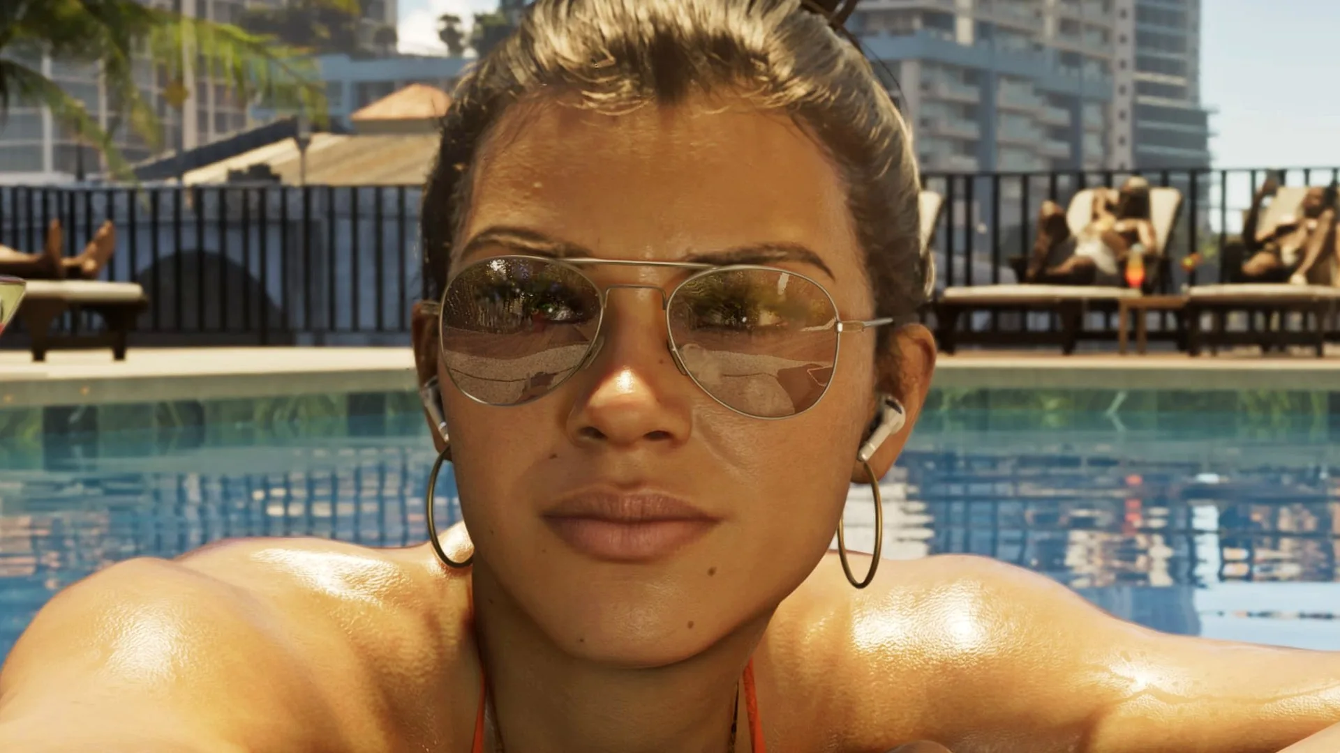 GTA 6 voice actors and cast: Lucia reclines by a pool in Vice City, her hair pulled back and her eyes obscured by fashionable sunglasses.